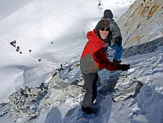 10 10 Jerome Ryan Climbing Down East Col Finally it was my turn to grab the fixed rope and descend the 125m 40-45 degree snow and rock face. Palde and Pemba Rinjii cut steps for me to make it easier and safer. The only real danger was falling rocks and ice kicked loose by the other group�s porters descending at the same time.